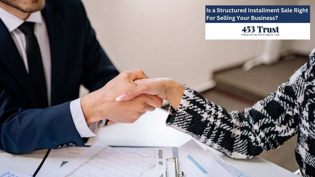 Two business people are shaking hands over documents, symbolizing a deal or agreement.